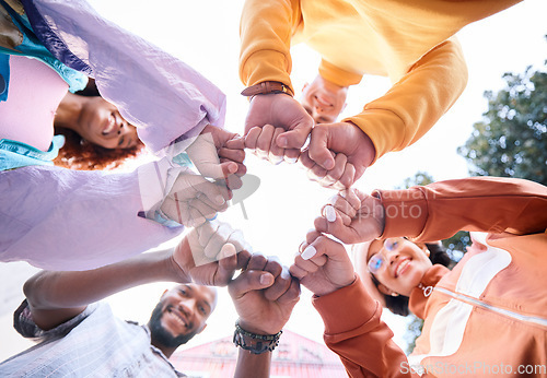 Image of Friends, hands and people fist bump outdoor for trust, community and fun circle. Diversity, happiness and below gen z group of men and women with solidarity for teamwork, youth and freedom in nature