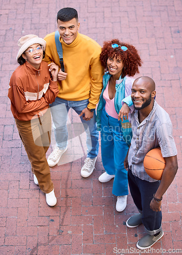 Image of Happy friends, city and portrait with a basketball outdoor for sports, fashion and fun. Diversity, gen z and student group of men and women smile for adventure and relax on urban street from above