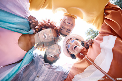 Image of Portrait, smile and a group of friends in a huddle outdoor together for freedom, bonding or fun from below. Diversity, travel or summer flare with happy men and women laughing outside on vacation