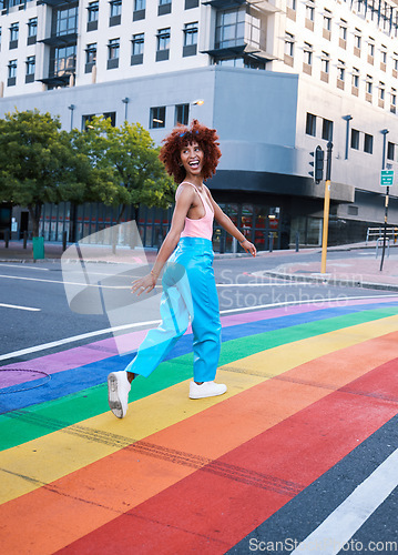 Image of Happy, walking and a woman on a pride street for a celebration of freedom of love. Smile, city and a girl or person in support of lgbt community on a rainbow road for equality, excited and identity