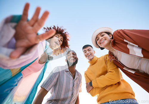 Image of Portrait, smile and a group of friends on a blue sky outdoor together for freedom, bonding or fun from below. Diversity, travel or summer with happy men and women laughing outside on vacation