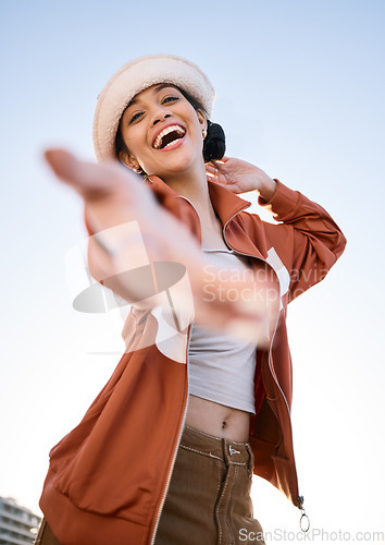 Image of Excited woman, portrait and helping hand, offer and invitation outdoor in low angle. Funny, palm and person giving assistance for support, care and laughing in acceptance of handshake sign to welcome