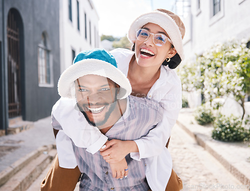 Image of Happy couple, love or piggyback portrait in city to travel on romantic date to play a funny outdoor game. Smile, interracial or happy man carrying gen z woman in silly, goofy or playful joke together