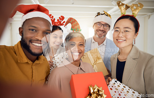 Image of Business people, Christmas selfie and group with smile, present or portrait for celebration, diversity or party. Men, women and photography for xmas memory, friends and gift box for workplace culture