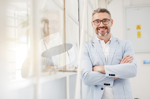Image of Smile, executive and portrait of a businessman with arms crossed in an office for professional pride. Happy, corporate and a mature manager or ceo working with confidence in workplace management