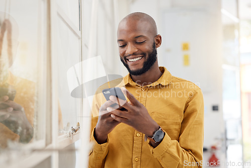 Image of Happy black man, smartphone and typing in office for social media, networking and mobile contact. Business employee smile with cellphone, reading tech notification and information on digital news app