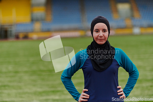 Image of A Muslim woman with a burqa, an Islamic sportswoman resting after a vigorous training session on the marathon course. A hijab woman is preparing for a marathon competition