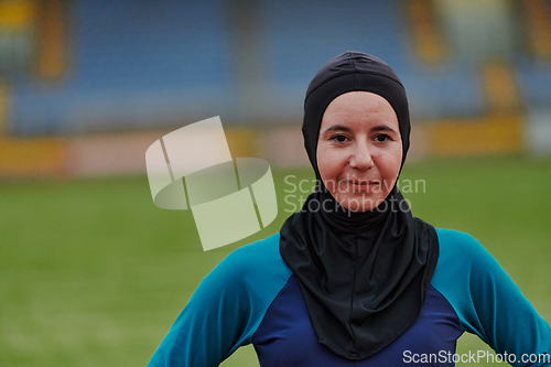 Image of A Muslim woman with a burqa, an Islamic sportswoman resting after a vigorous training session on the marathon course. A hijab woman is preparing for a marathon competition