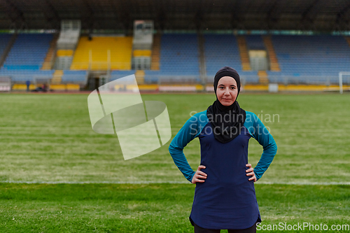 Image of A Muslim woman with a burqa, an Islamic sportswoman resting after a vigorous training session on the marathon course. A hijab woman is preparing for a marathon competition