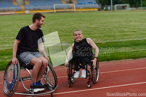 Image of A woman with disability in a wheelchair talking with friend after training on the marathon course