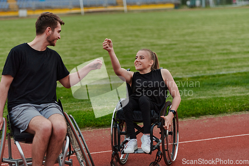 Image of A woman with disability in a wheelchair talking with friend after training on the marathon course