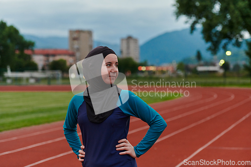 Image of A Muslim woman with a burqa, an Islamic sportswoman resting after a vigorous training session on the marathon course. A hijab woman is preparing for a marathon competition