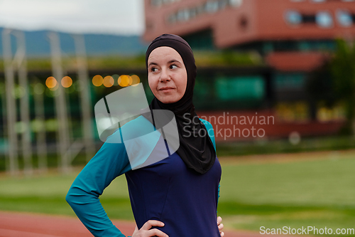 Image of A Muslim woman with a burqa, an Islamic sportswoman resting after a vigorous training session on the marathon course. A hijab woman is preparing for a marathon competition