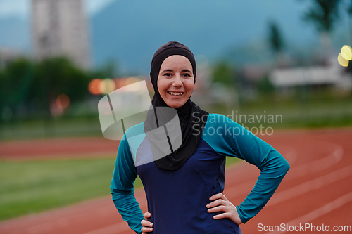 Image of A Muslim woman with a burqa, an Islamic sportswoman resting after a vigorous training session on the marathon course. A hijab woman is preparing for a marathon competition