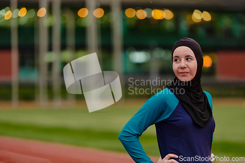 Image of A Muslim woman with a burqa, an Islamic sportswoman resting after a vigorous training session on the marathon course. A hijab woman is preparing for a marathon competition