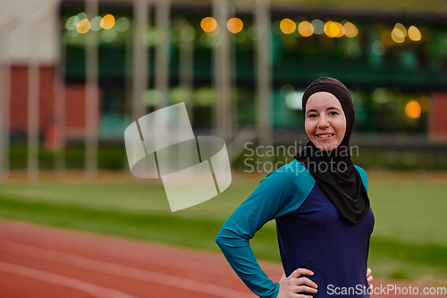 Image of A Muslim woman with a burqa, an Islamic sportswoman resting after a vigorous training session on the marathon course. A hijab woman is preparing for a marathon competition