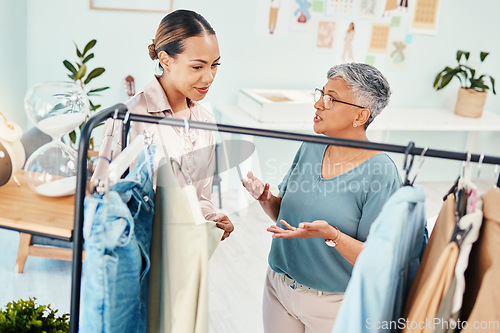 Image of Consultant, fashion and shopping with client in shop for advice on fabric or products on promotion. Customer, retail sale or women talking in boutique mall for clothes deal, help or discount offer