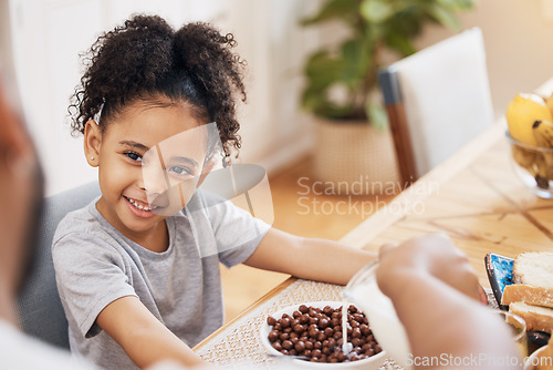 Image of Kitchen, breakfast cereal and happy family child smile for morning food, meal and parent pour milk. Home, happiness and young kid, youth girl and ready for nutrition, hungry and eating in Brazil