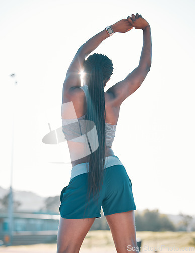 Image of Stretching, exercise and sports woman outdoor at a stadium for workout, training and warm up. Back of athlete person for muscle stretch, fitness and wellness or flexibility for a run or competition