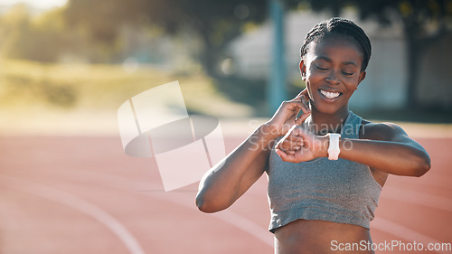 Image of Time, watch and exercise with a woman outdoor on a track for running, training or workout. African athlete person at stadium for goals, fitness and body wellness or check pulse for progress and space