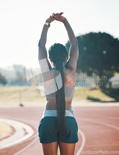 Image of Sports, stretching and exercise with a woman outdoor on a track for running, training or workout. Behind African athlete person at stadium for arm stretch, fitness and muscle warm up or body wellness