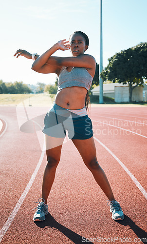 Image of Woman, sports and exercise or stretching outdoor on a track for running, training or workout. African athlete person at stadium for arm stretch, fitness and muscle warm up or body wellness