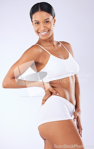 Image of Portrait, underwear or woman in studio for body health or wellness on white background for diet to lose weight. Self care, smile or happy model with smooth stomach, glow or skin at spa for beauty