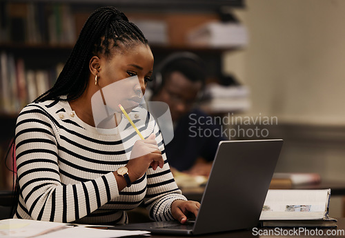Image of Student, woman and thinking on laptop in library for studying, research and university ideas or focus. Young african person on computer for reading and e learning goals, education or online planning