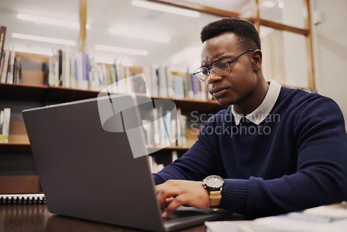 Image of Student, frustrated and black man typing on a laptop in university or college campus angry due to assignment project. Online, studying and young person prepare for internet exam or doing research