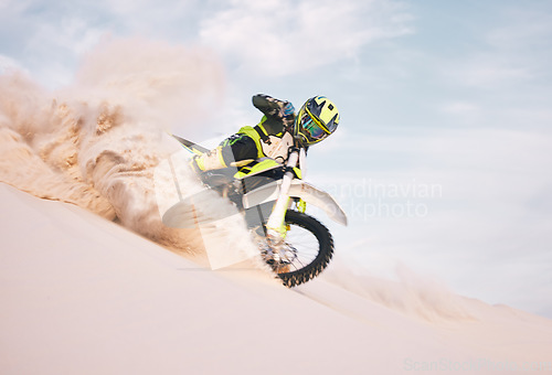 Image of Desert, motorbike and person with sports, ride and journey with freedom, training for competition and challenge. Outdoor, driver and rider practice, extreme action and balance on bike on sand dunes