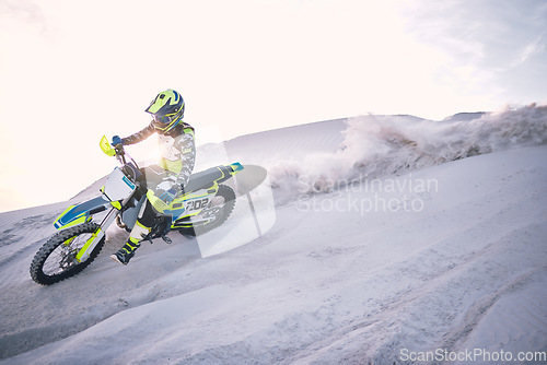 Image of Bike, dust and speed with a man on space riding a vehicle in the desert for adventure or adrenaline. Motorcycle, training and mockup with an athlete on sand in nature for freedom or extreme sports