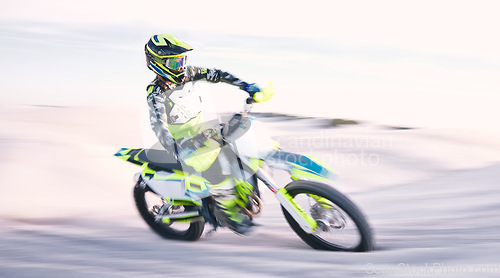 Image of Bike, sand and speed with a sports man riding a vehicle in the desert for adventure or adrenaline. Motorcycle, training and freedom with an athlete outdoor in nature for power or active competition