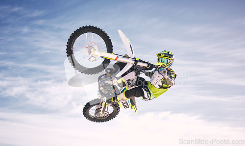 Image of Sky, jump and man on off road motorbike for practice, training and extreme sports energy in nature. Professional dirt biking adventure challenge, person in clouds and danger in motorcycle competition