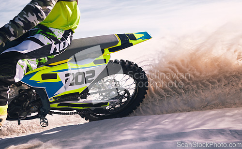 Image of Sports, sand and person on motorbike in action for training, workout and challenge in desert. Extreme transport, travel and cyclist with motorcycle for adventure, freedom and adrenaline for speed