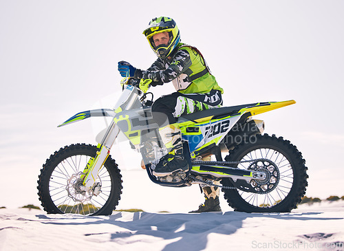 Image of Sports, desert and portrait of man on motorbike for race training, workout and challenge on sand. Extreme transport, travel and male cyclist with motorcycle for adventure, freedom and adrenaline