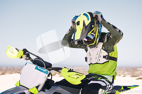 Image of Sports, action and man on motorbike in desert for training, workout and race challenge on sand. Extreme transport, travel and cyclist with helmet on motorcycle for adventure, freedom and adrenaline