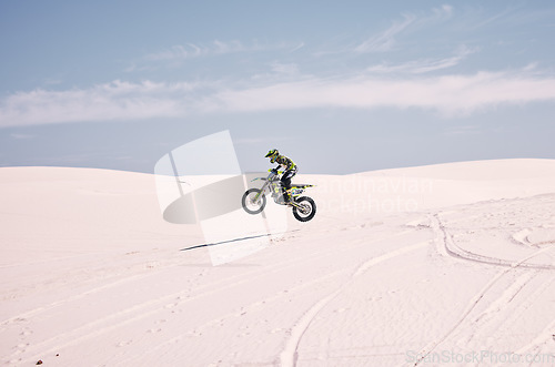 Image of Bike, mockup and balance with a man in the desert riding a vehicle for adventure or adrenaline. Motorcycle, space and training on sand with an athlete outdoor in nature for freedom or active power