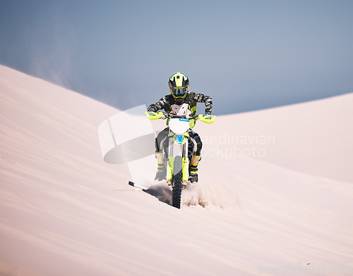 Image of Dune, motorbike and man athlete training in desert for extreme sports race or competition. Fitness, sand and male biker on hill for dirt biking challenge, stunt or skill for practice with motorcycle.