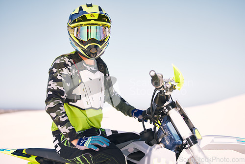 Image of Sports, desert and man with helmet on motorbike for training, workout and challenge on sand. Extreme transport, travel and cyclist with motorcycle for adventure, freedom and adrenaline for action