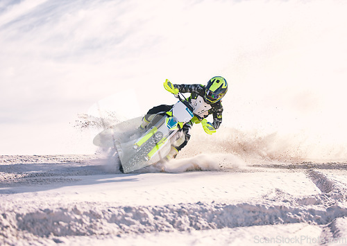 Image of Motorcycle, dust and speed with a man in the desert riding a vehicle for adventure or adrenaline. Bike, training and freedom with an athlete outdoor on sand in nature for power or extreme sports