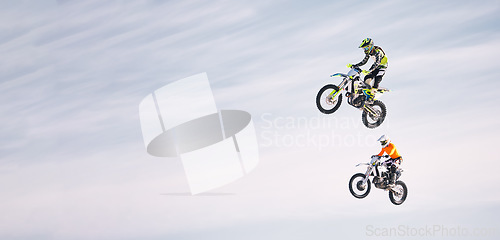 Image of Sky, jump and men on motorbike together for practice, training and extreme sports energy in mockup. Professional dirt biking challenge, friends in air and danger with off road motorcycle competition.