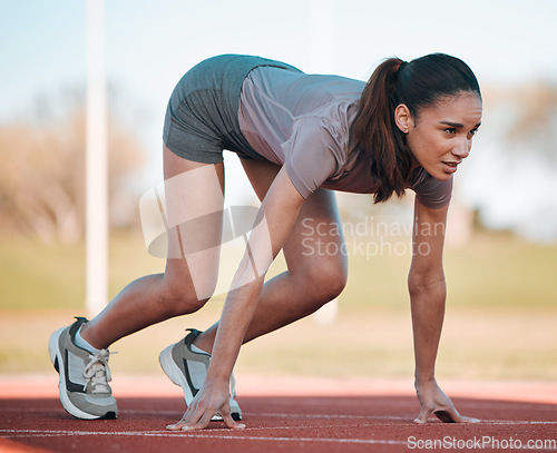 Image of Woman, fitness and running start in athletics, motivation or competition on stadium or olympic track. Active female person or runner ready in sprint marathon, cardio workout or outdoor performance