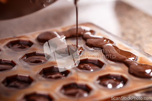 Image of Pouring chocolate in mold