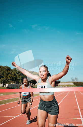 Image of Happy woman, running and winning by finish line in race, competition or marathon on outdoor stadium track. Female person or runner in celebration for victory, achievement or sports accomplishment