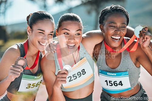 Image of Happy women, award and celebration in olympic winning, running or competition together on stadium track. Group of athletic people smile in happiness, medal or victory in sports marathon or success