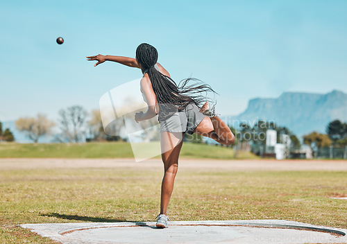 Image of Shot put, woman and athlete throw in competition, championship or training for field event with metal or steel weight. Throwing, ball or female in athletics sport on outdoor field for olympics