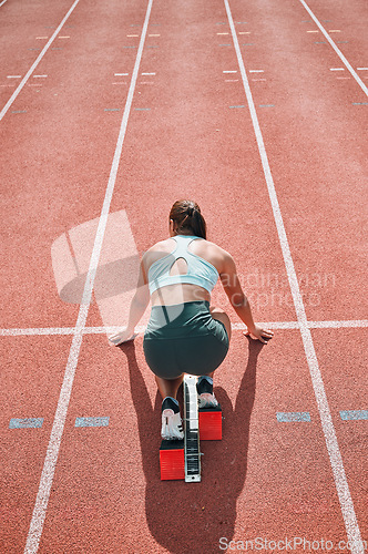 Image of Start, running and fast with woman on race track for sports, competition and marathon. Exercise, health and wellness with runner training in stadium for challenge, speed and energy performance