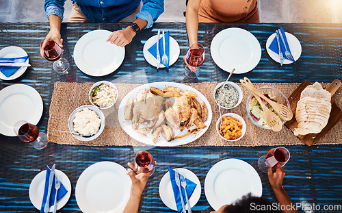 Image of Wine, food or top of friends in restaurant to relax on holiday vacation at a party event together. Food, group celebration or hands of people eating chicken at table for lunch, dinner or brunch meal