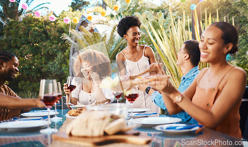 Image of Group of friends at lunch, party in garden with smile, eating and happy event with diversity. Outdoor dinner, men and women at table with food, wine and talking together in backyard with celebration.