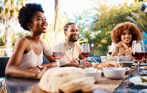 Image of Friends at lunch, conversation in garden and happy event with diversity, food and wine, outdoor bonding together. Dinner party, men and women at table, people eating and talking in backyard in summer